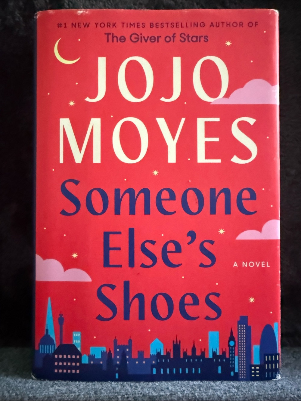 Jojo Moyes "Someone Else's Shoes" - Red Hardcover Novel